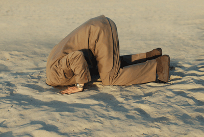 suited-man-head-in-sand.png